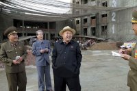 Создать мем Kim Jong Un in a constructive site laughing