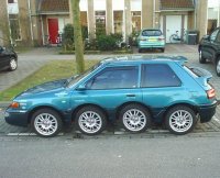 Car on 8 wheels parked