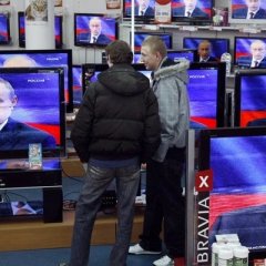 Putins face in the TV