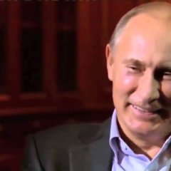 Vladimir Putin laughs