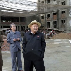 Kim Jong Un in a constructive site laughing