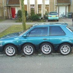 Car on 8 wheels parked